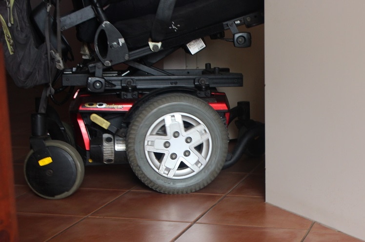 The wheels of Mark Moodie's wheelchair pictured in his tiled kitchen