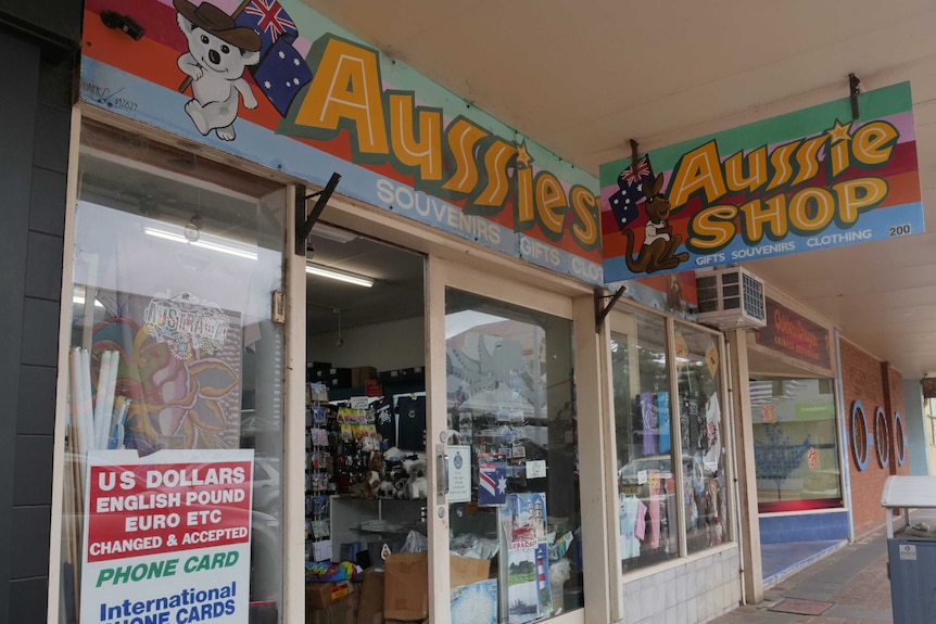 The Aussie Shop front of store, a colourful sign with koalas and kangaroos. The door is open and you can see souvenirs