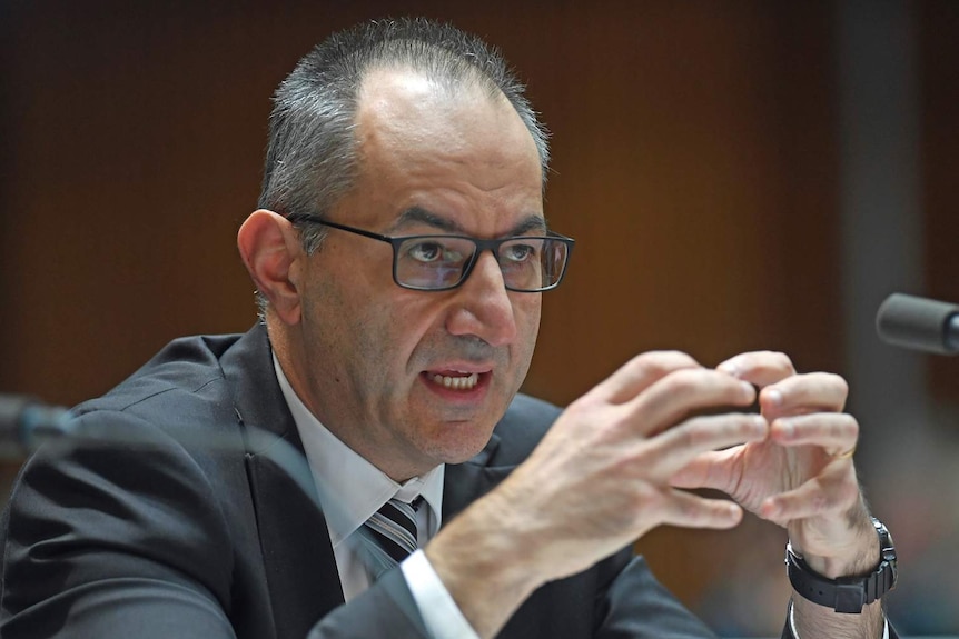 Secretary of the Immigration Department Michael Pezzullo touches his fingers together as he speaks during Senate Estimates.