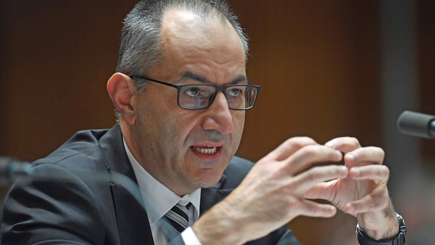 Secretary of the Immigration Department Michael Pezzullo touches his fingers together as he speaks during Senate Estimates.