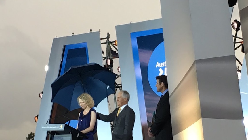 Malcolm Turnbull holds an umbrella for Catherine Keenan while she makes her speech.