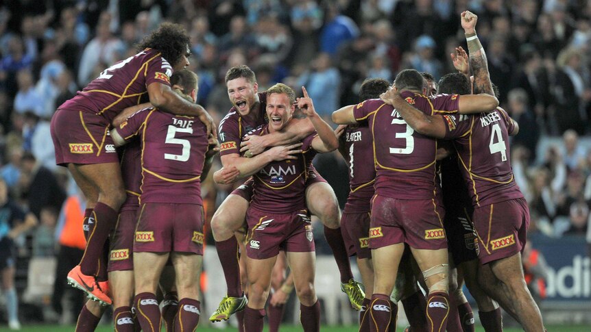 Eight is great ... the Maroons celebrate a hard-fought series win at a hostile Olympic stadium.