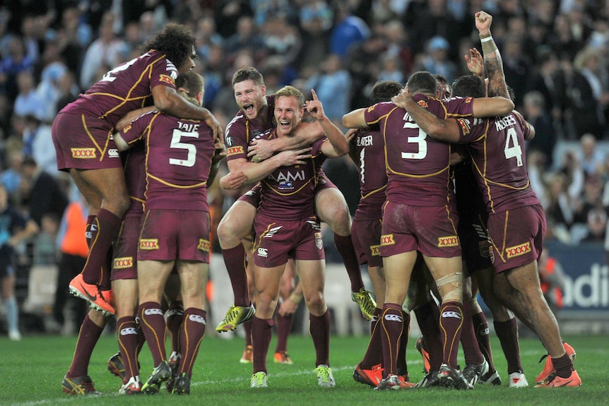 Eight is great ... the Maroons celebrate a hard-fought series win at a hostile Olympic stadium.