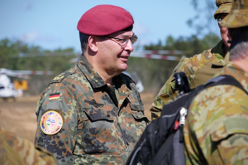 A man in a red beret and army uniform with a German patch