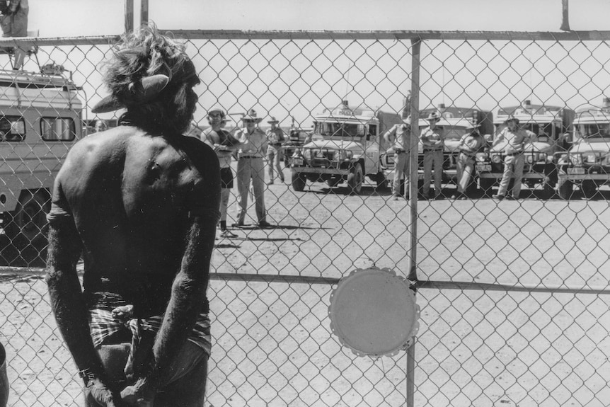 Aboriginal activist Don McLeod eyes off authorities during the Noonkanbah dispute after leading a ceremony to reclaim the land.