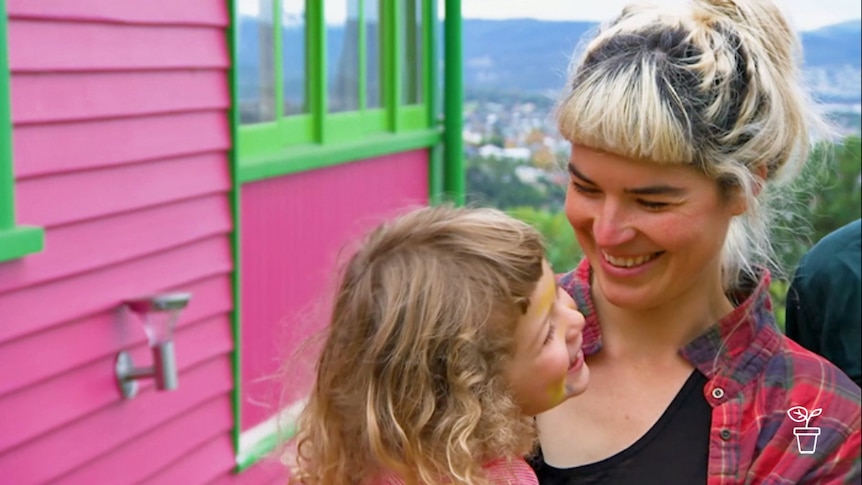 Lady holding child and smiling