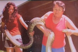 Ingham snake handler Virginia McGrath (right) and daughter Vanessa with a 16-kilogram, five-metre scrub python in 2008.