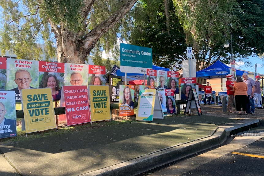 Signs for political parties outside a polling station at Runaway Bay