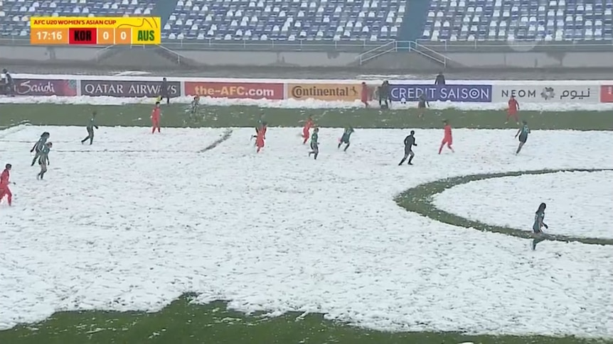 An image from a soccer game being played in the snow.