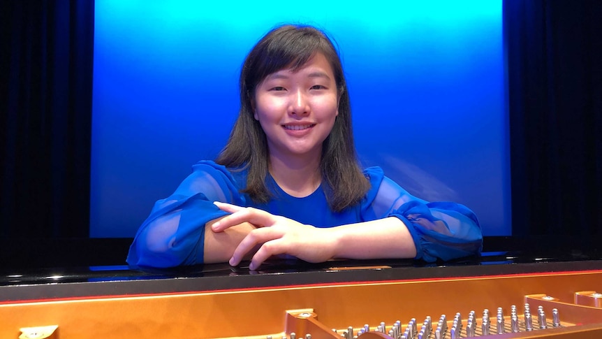 A 17-year-old girl in front of a grand piano