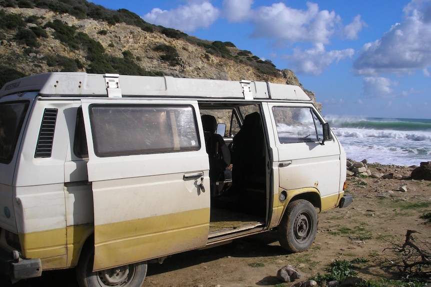 A van parked next to the ocean