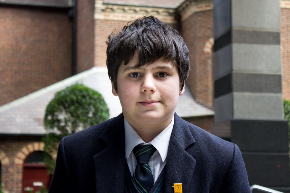 A teenage boy in school uniform