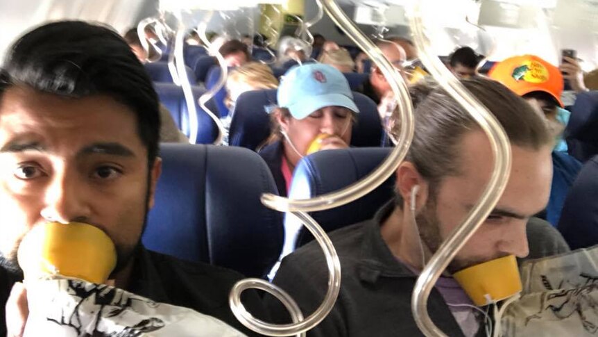 Passengers on Southwest Airlines wear oxygen masks.