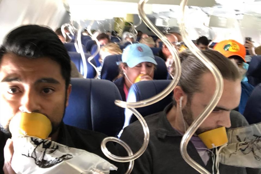 Passengers on Southwest Airlines wear oxygen masks.