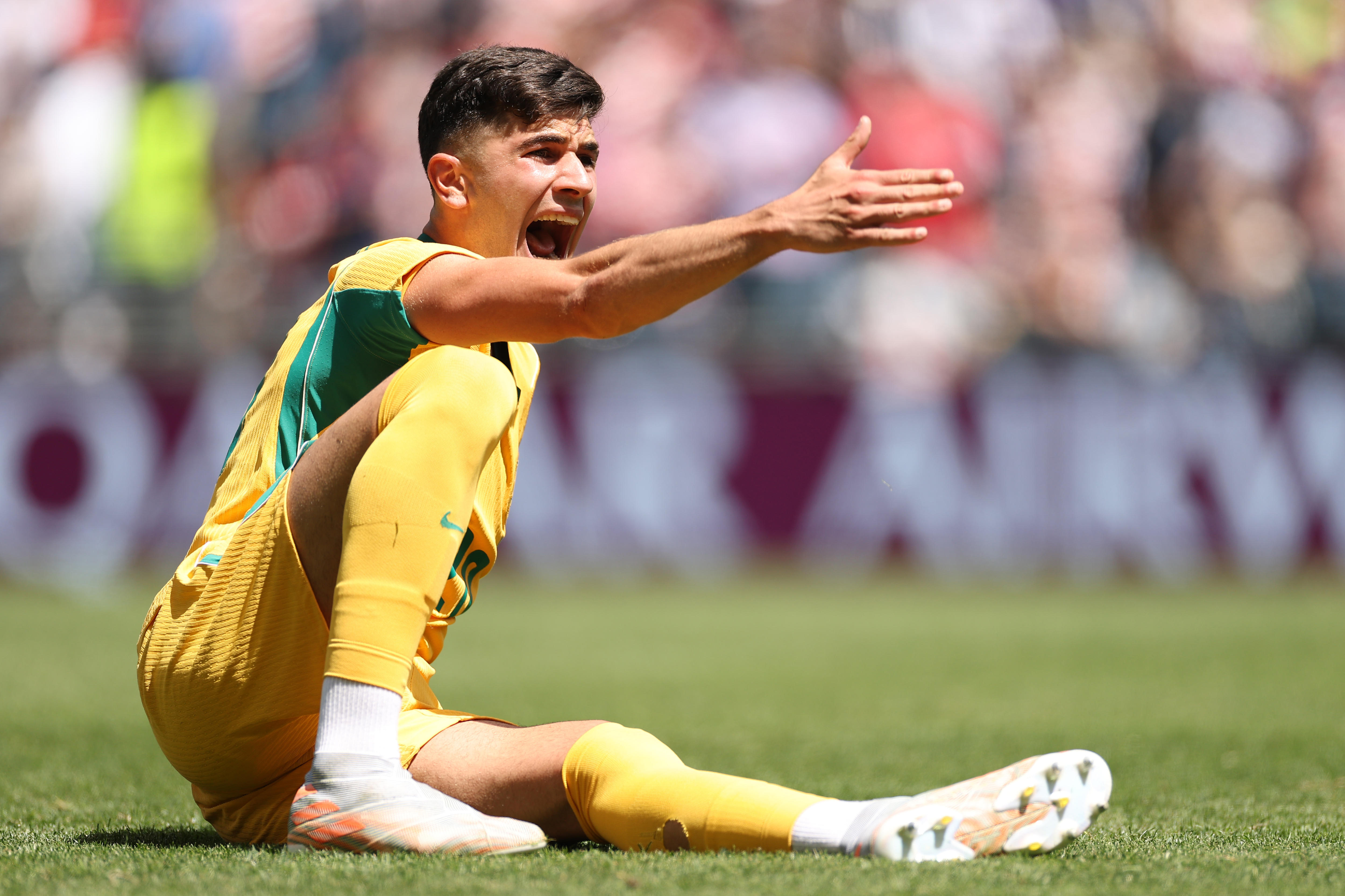 Cristian Volpato sits on the ground, gestures and yells
