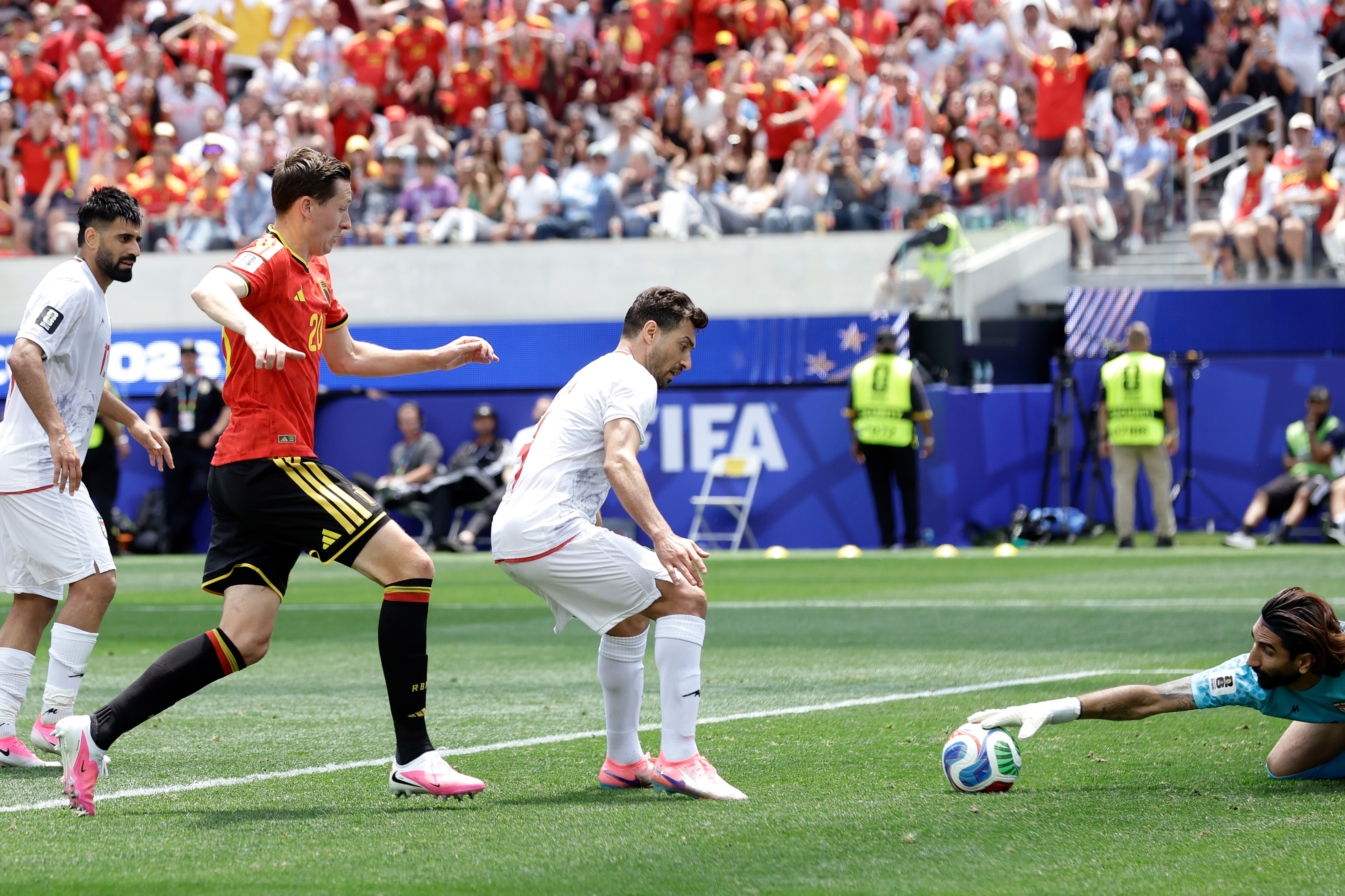 Alireza Beiranvand reaches out to grab the soccer ball. 