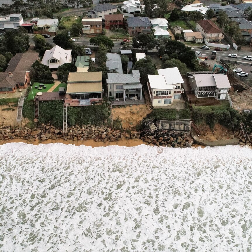 Waves close to houses at Wamberal Beach