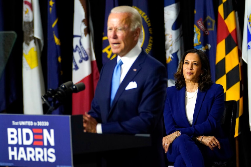 Democratic presidential candidate former Vice President Joe Biden speaks during a campaign event while Kamala Harris watches on