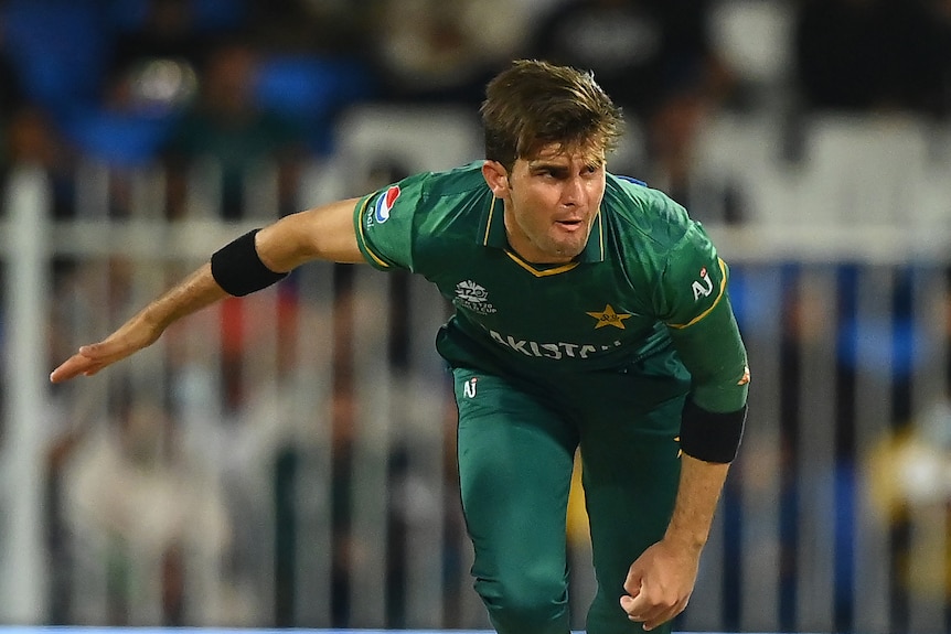 A Pakistan fast bowler is pictured mid-air in his follow through from a delivery at the T20 World Cup.