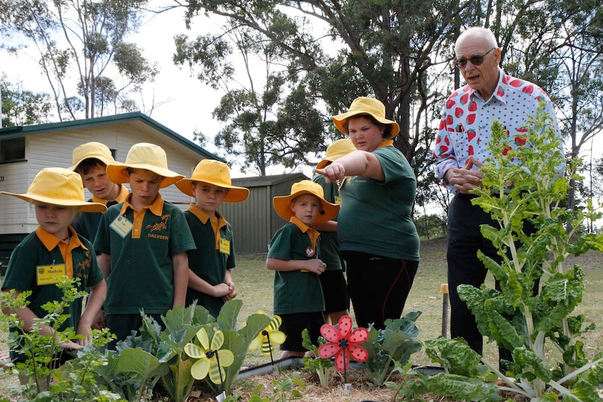 Students at Dalveen State School show their vegetable patch to Dr Karl.