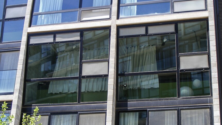Glass windows of an apartment block.