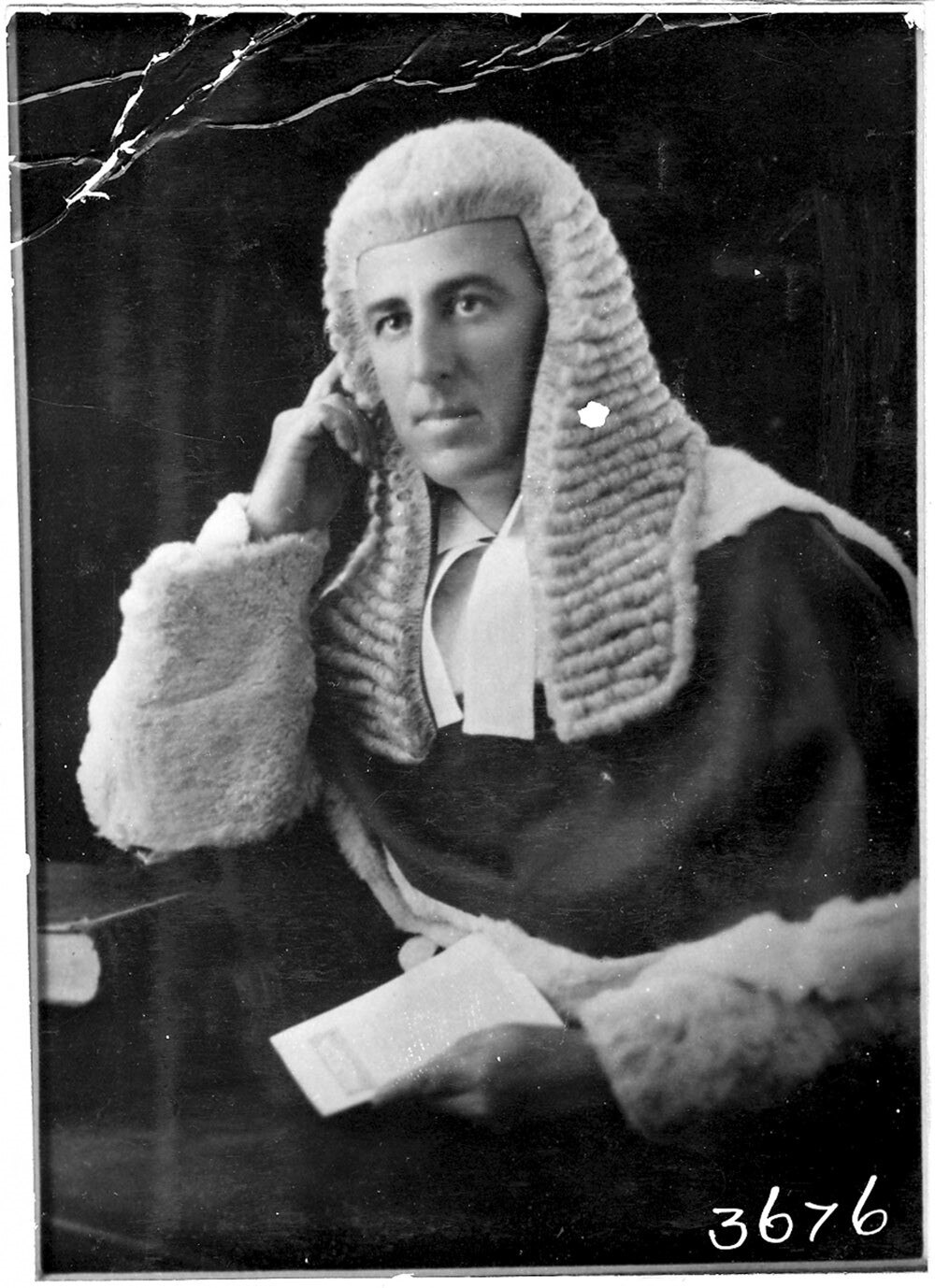A judge poses in a wig