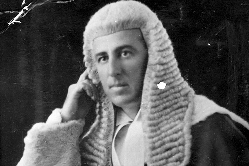 A judge poses in a wig