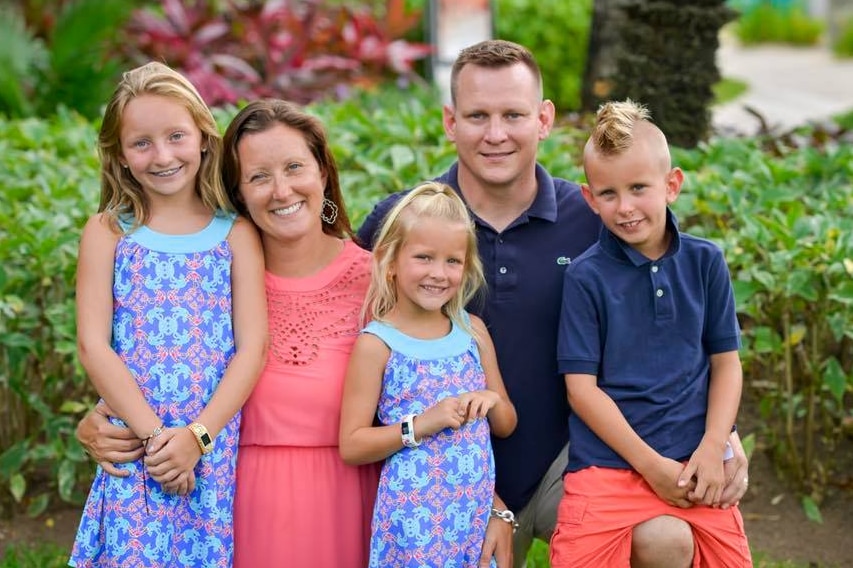 The Lowrance family poses in a tropical garden