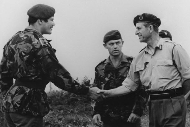 An old photo shows Prince Philip shaking hands with a Royal Marines soldier in 1953.