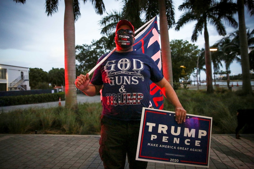 A man in a t-shirt reading 'God, Guns and Trump'
