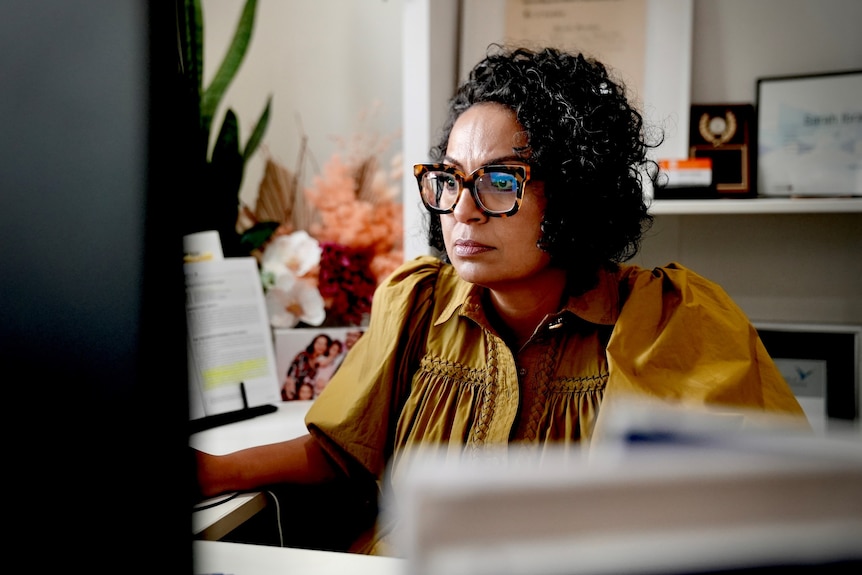 Sarah Ibrahim looking at her mortgage rate on the computer at her Sydney home in June 2022