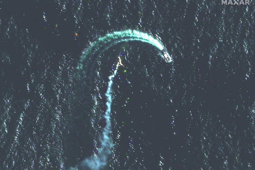 Satellite image shows a trail of smoke nearby a moving ship.