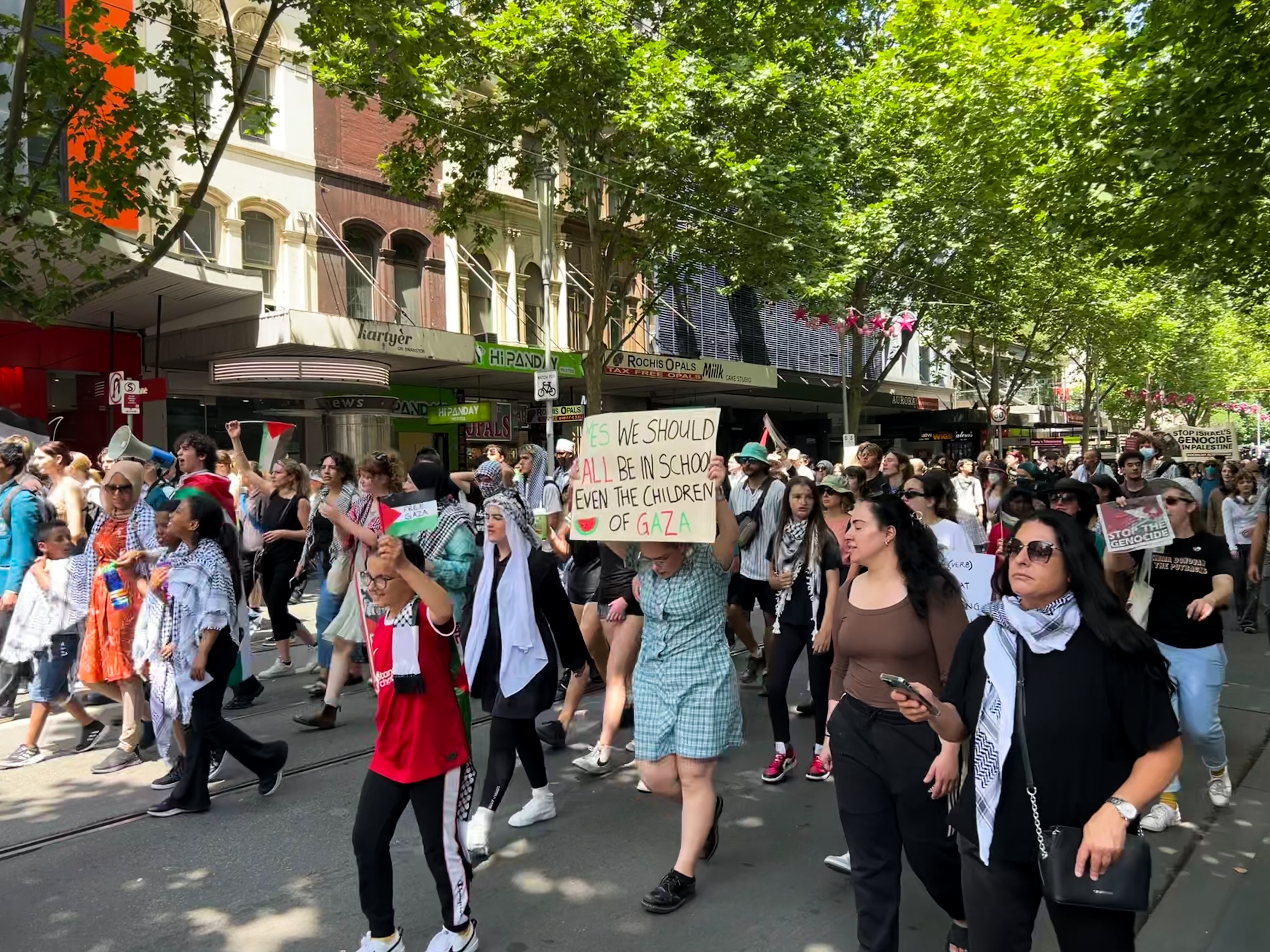 A protest crowd moves through Melbourne's CBD.