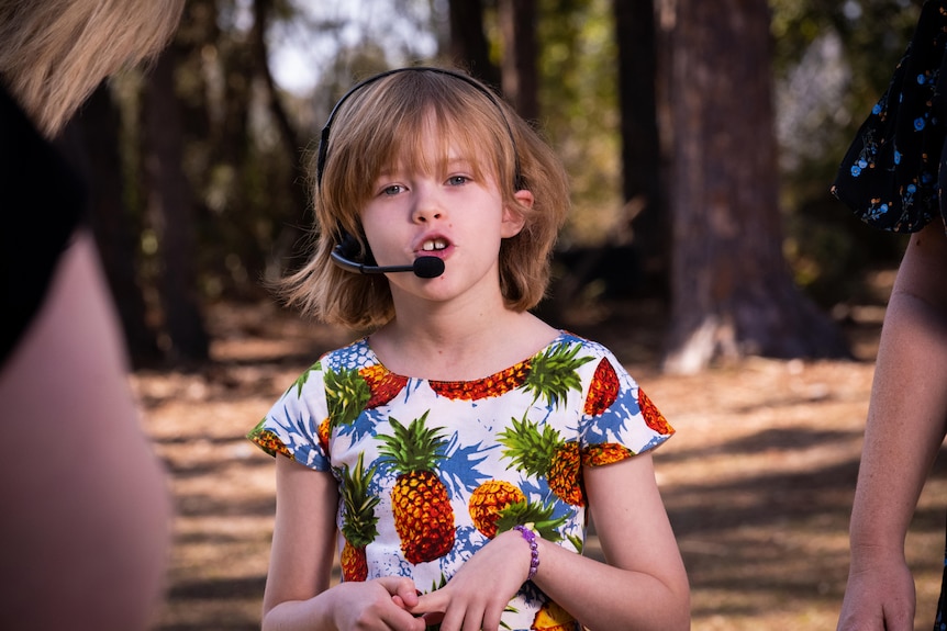 A little girl in a pineapple dress