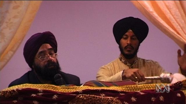 Two men in turbans conduct Sikh sermon
