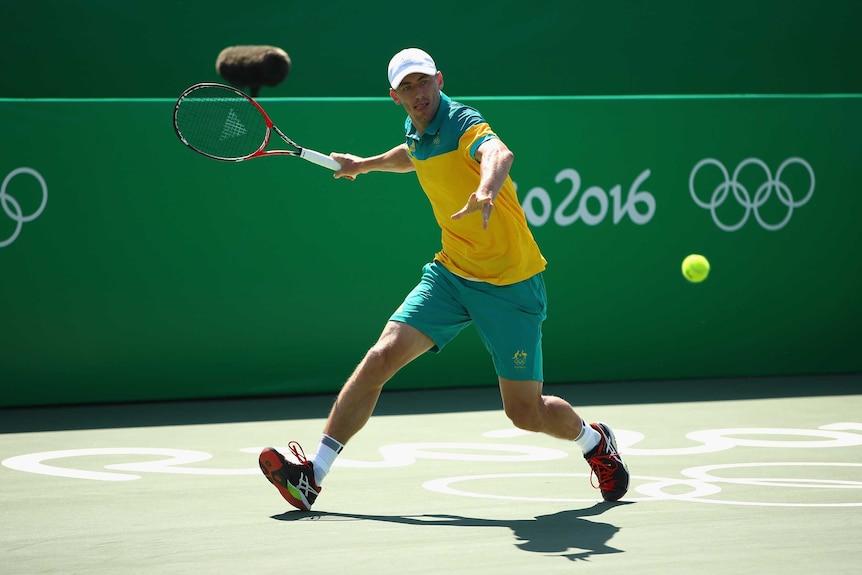 John Millman hits a forehand to Ricardas Berankis