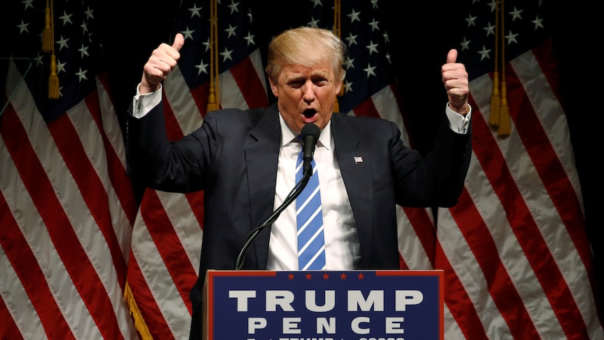 Donald Trump gives two thumbs up as he holds a rally with supporters in Council Bluffs, Iowa.