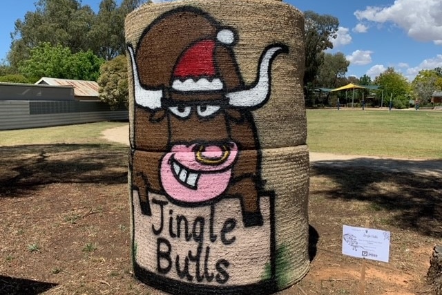 a bull is painted on a hay bale stack with the word 'jingle bulls' across it