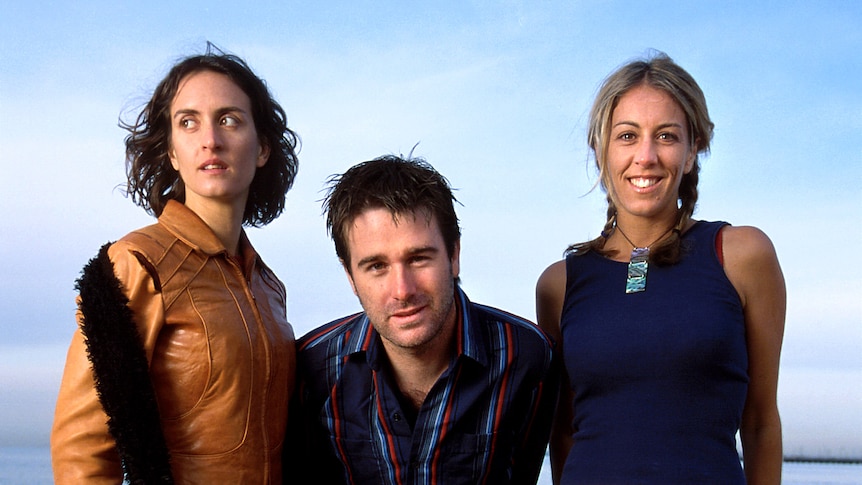 Vikki Thorn, Josh Cunningham and Donna Simpson of The Waifs pose for a group portrait on St Kilda Beach