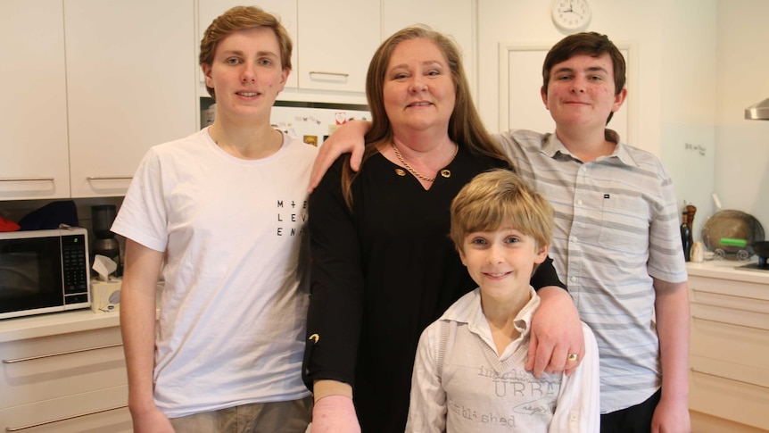 Karen van Gorp surrounded by her three sons.