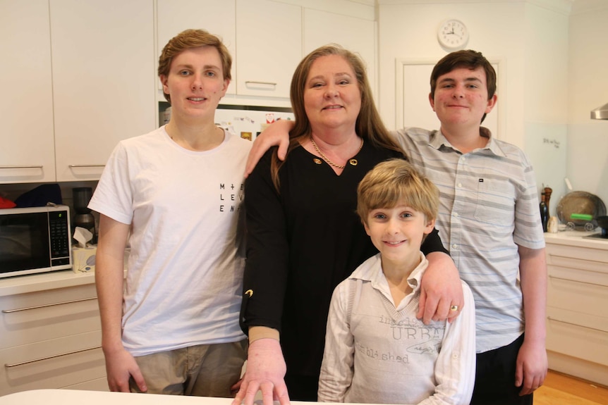 Karen van Gorp surrounded by her three sons.