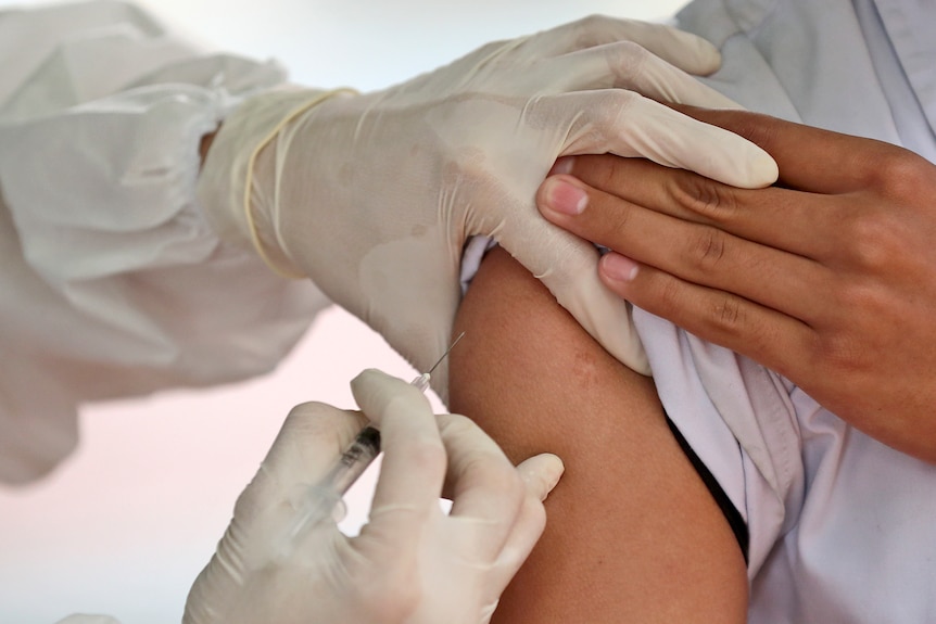 A medical worker gives a shot of the Sinovac COVID-19 vaccine