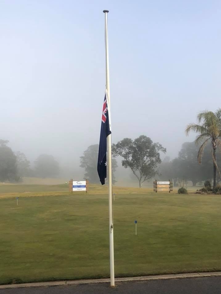 The Australian flag flies at half-mast at Shepparton Golf Club in Victoria on August 9, 2018.