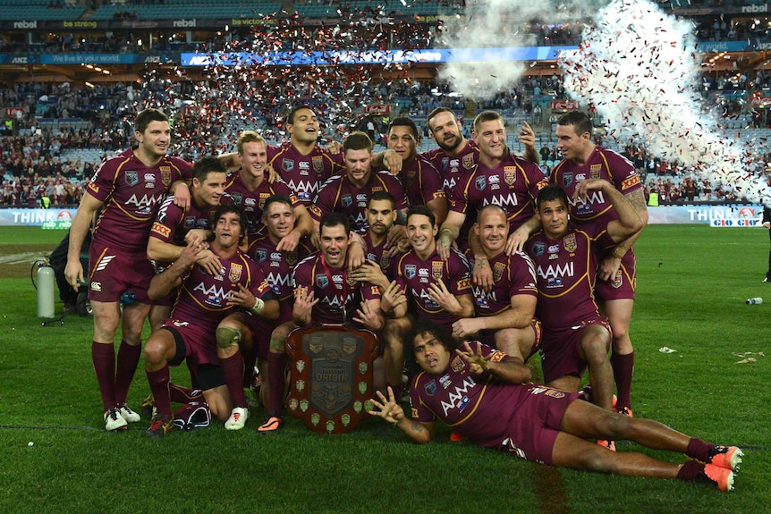 Queensland Maroons celebrate with the State of Origin shield after winning the 2013 series
