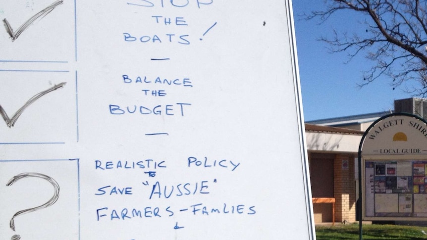 White board call for Federal Government to 'save Aussie farmers' as Federal Treasurer visits Walgett in NSW