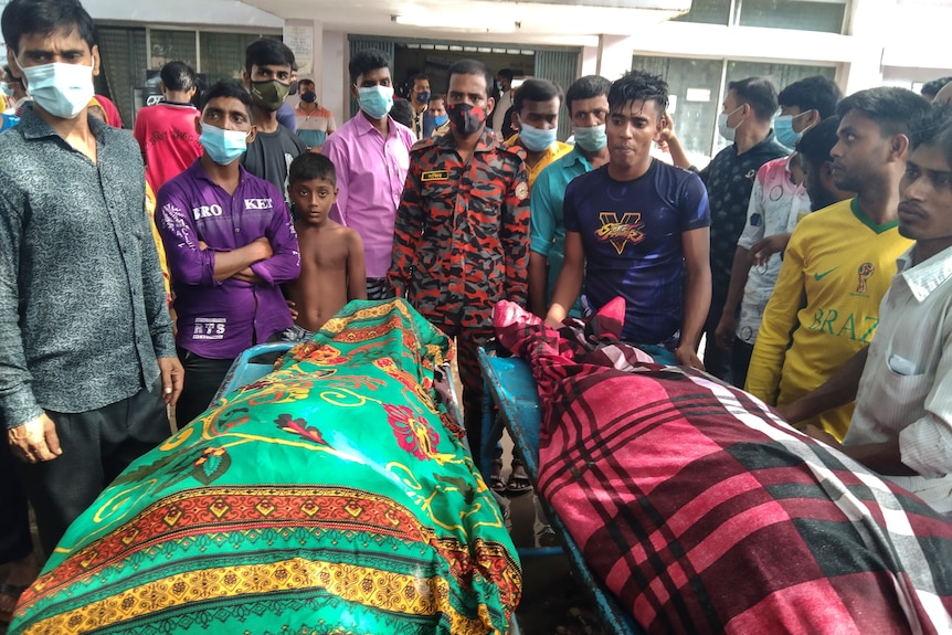 People gather around bodies of victims after lightning killed more than a dozen peopl