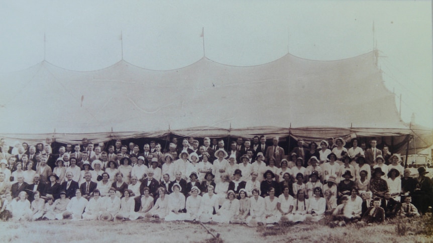 An independent Pentecostal group gathers in Brisbane in the 1930s in front of the tent in which they would congregate.