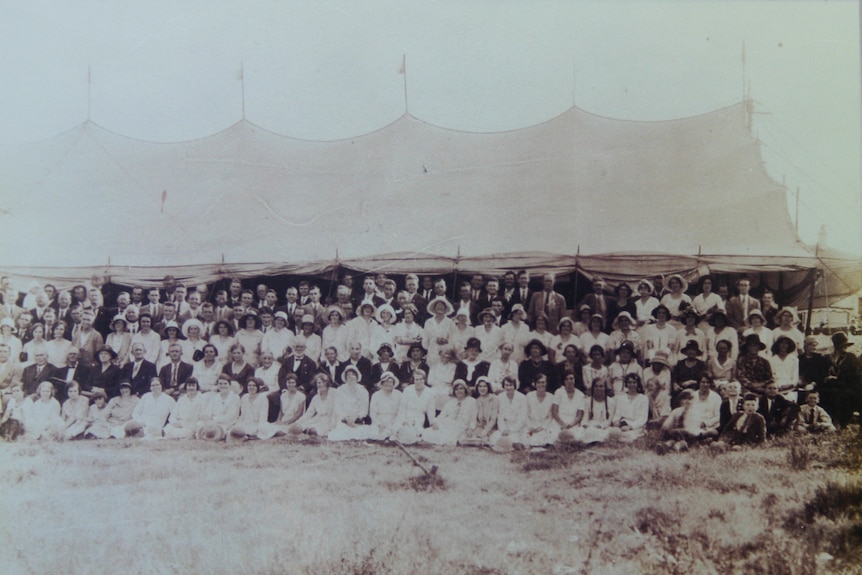 An independent Pentecostal group gathers in Brisbane in the 1930s in front of the tent in which they would congregate.