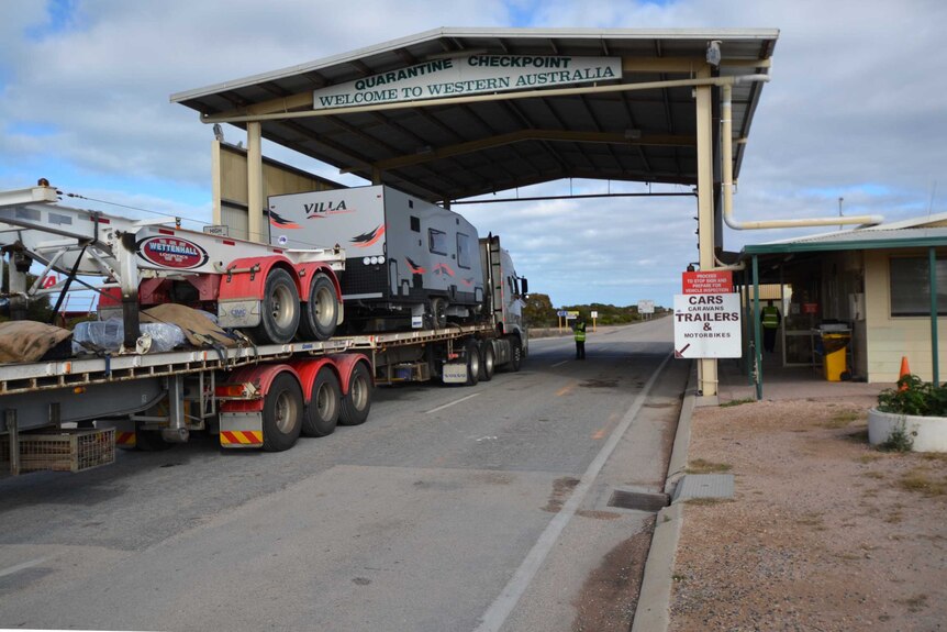 A truck rolls through the quarantine checkpoint at Eucla, on the WA-SA border.