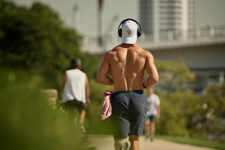 man jogs shirtless in the heat